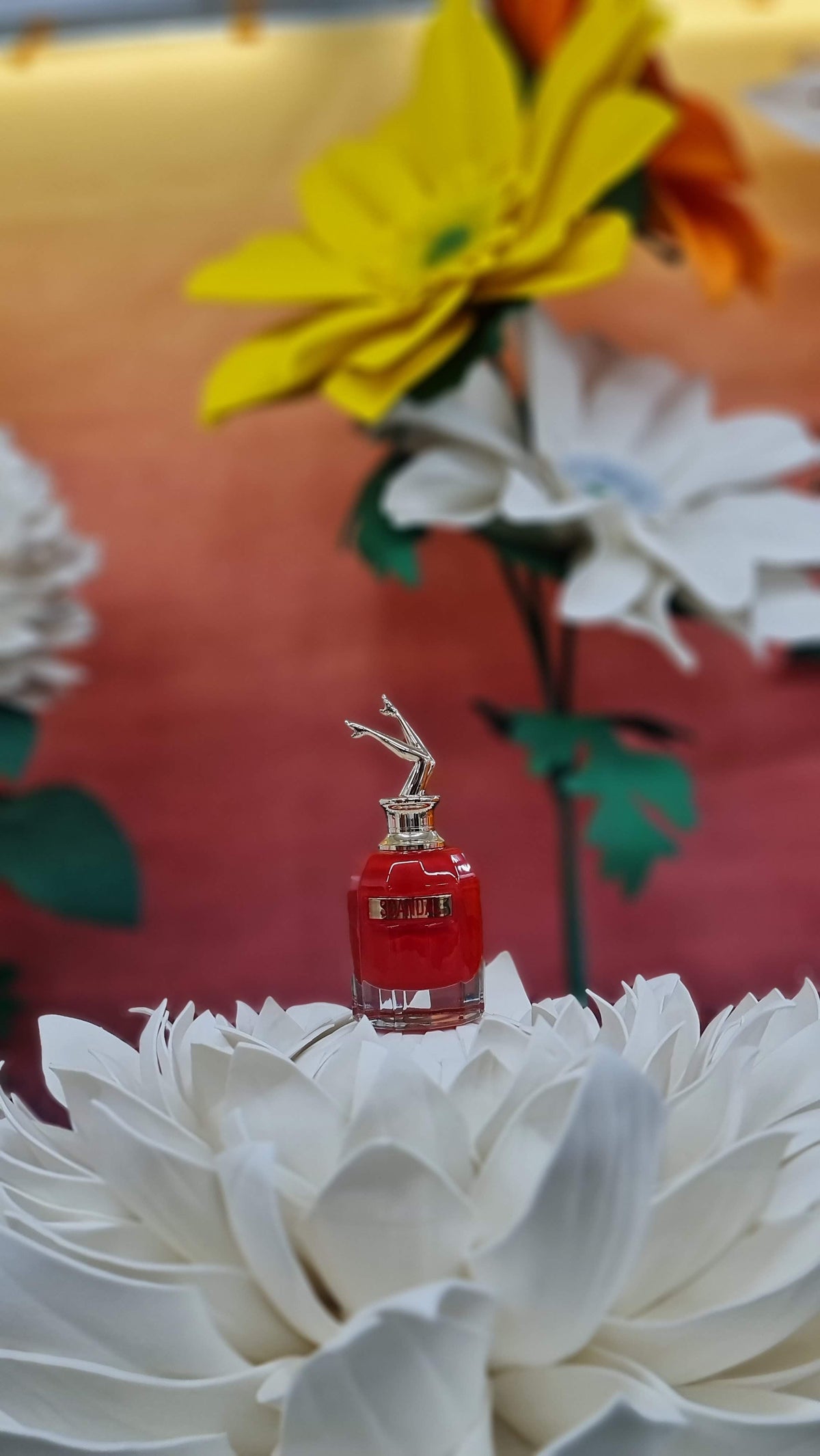 Jean Paul Gaultier Scandal perfume on a giant white flower in the video set