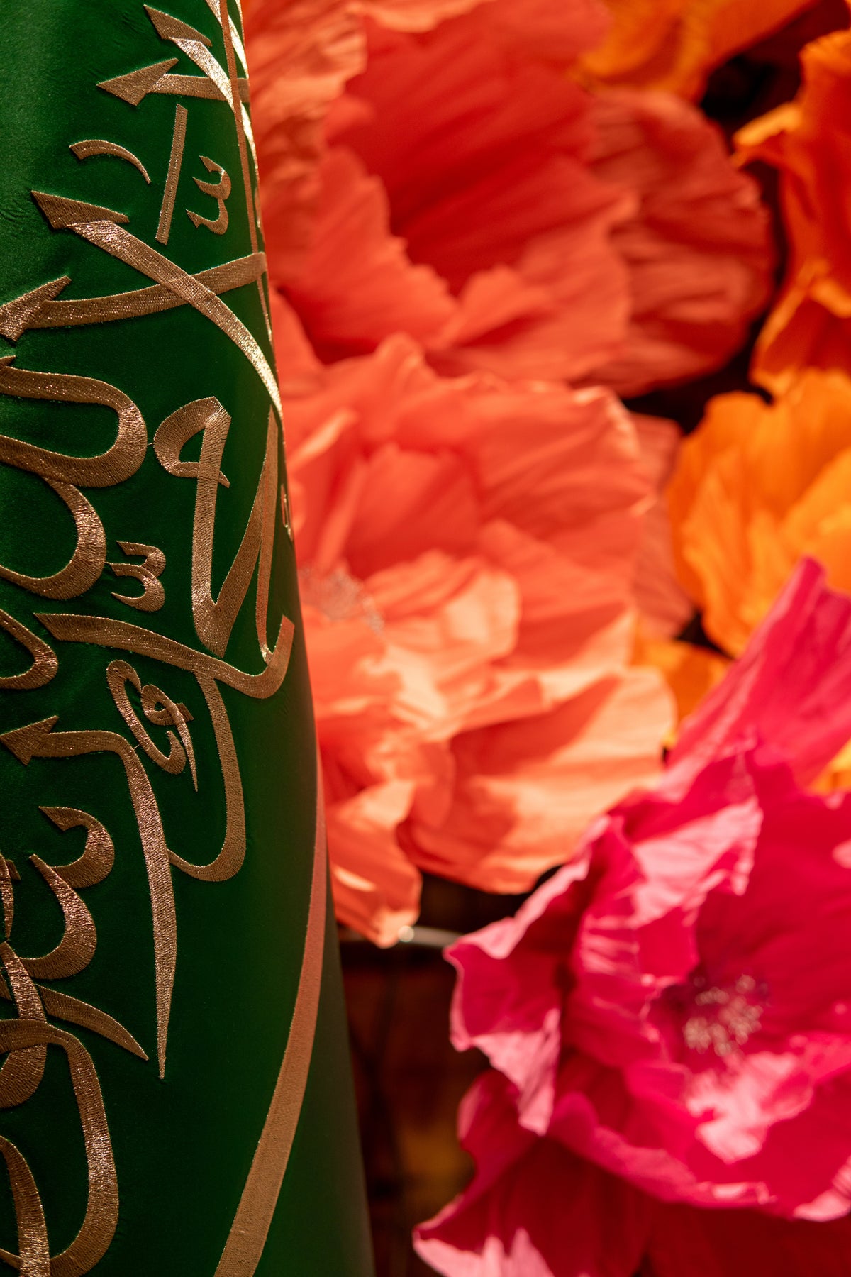 Coral and hot pink giant flowers beside the Saudi Arabian flag - royal wedding in Riyadh