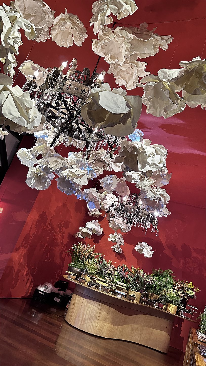 Giant white flowers in EVA foam against a terracotta backdrop — wedding wall panel