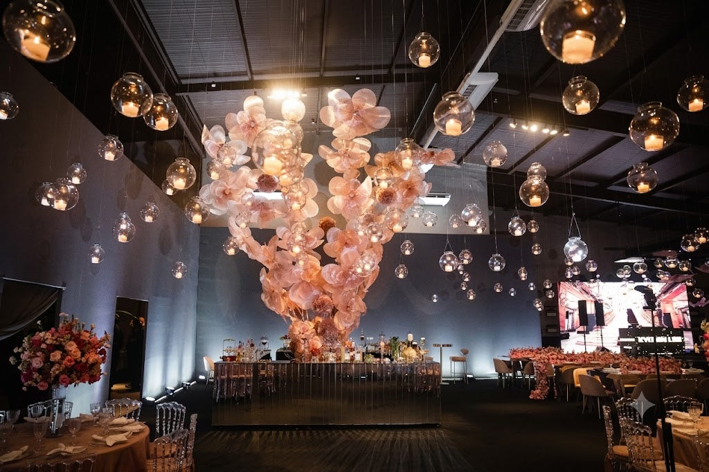 Giant organza flower sculptures surrounding the cake table - Sweet 15 celebration