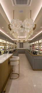 Suspended floral installation framing the store's gold pendant lights