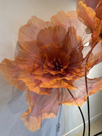 Overview of the booth decorated with giant organza flowers