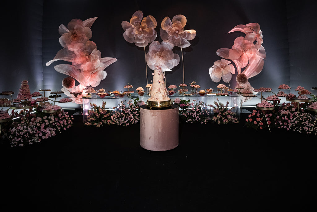 Close-up of an illuminated rosé giant organza flower at the Sweet 15 celebration