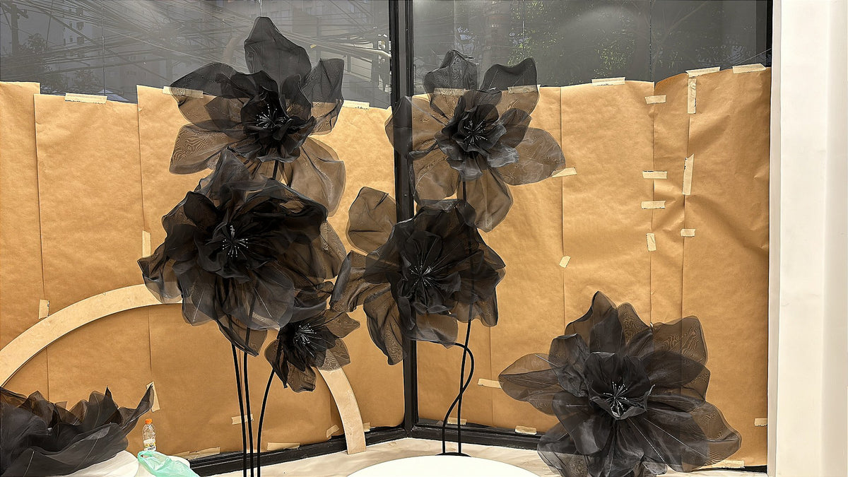 Curved stems supporting the giant organza flowers in the storefront