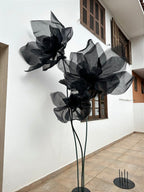 Close-up of black organza's transparency under the storefront lighting