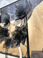 Composition of giant organza flowers around the products on display