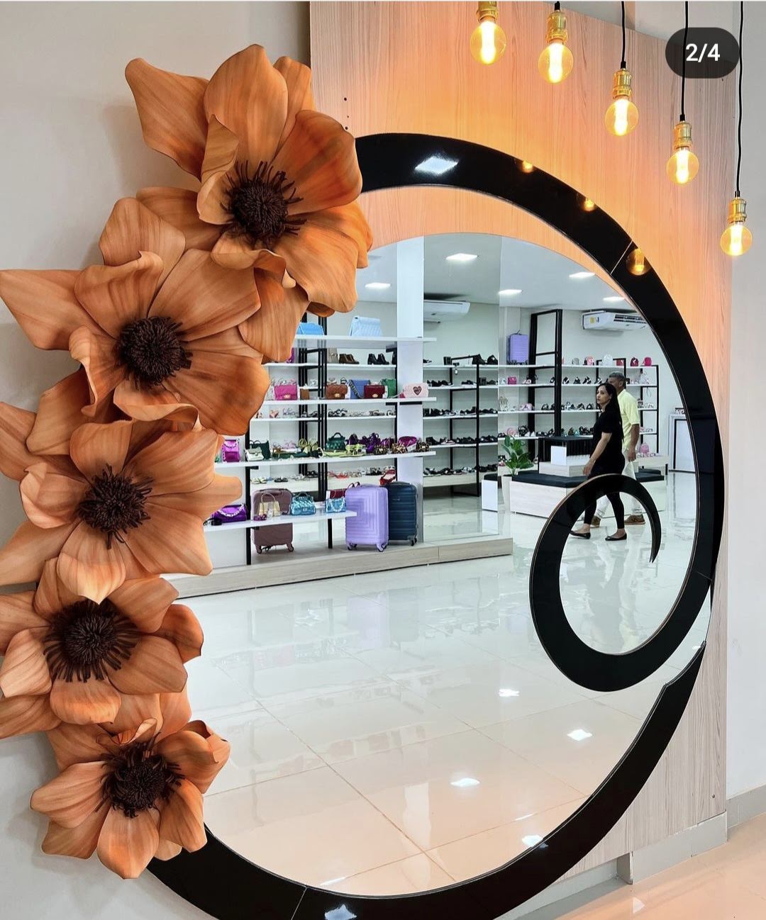 Circular mirror framed by giant EVA foam flowers - storefront installation