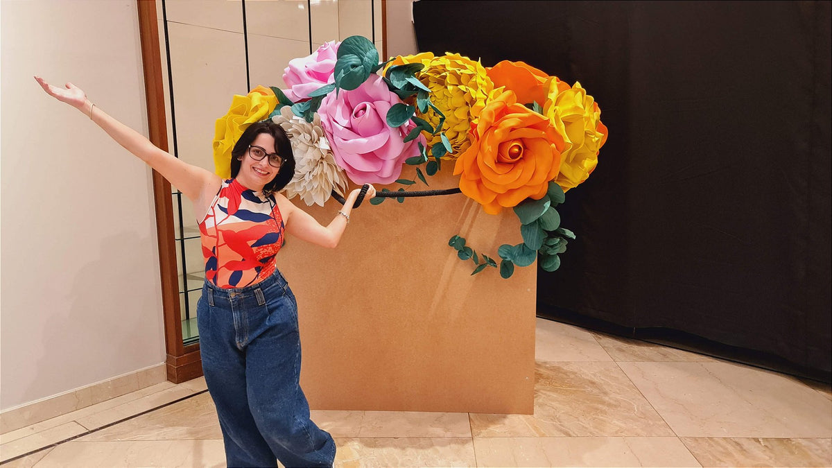 Floor display with giant roses in warm yellow and orange tones