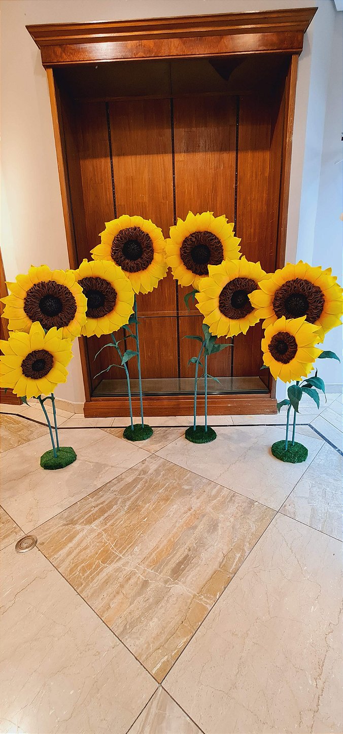 Giant flower composition framing the exhibition entrance