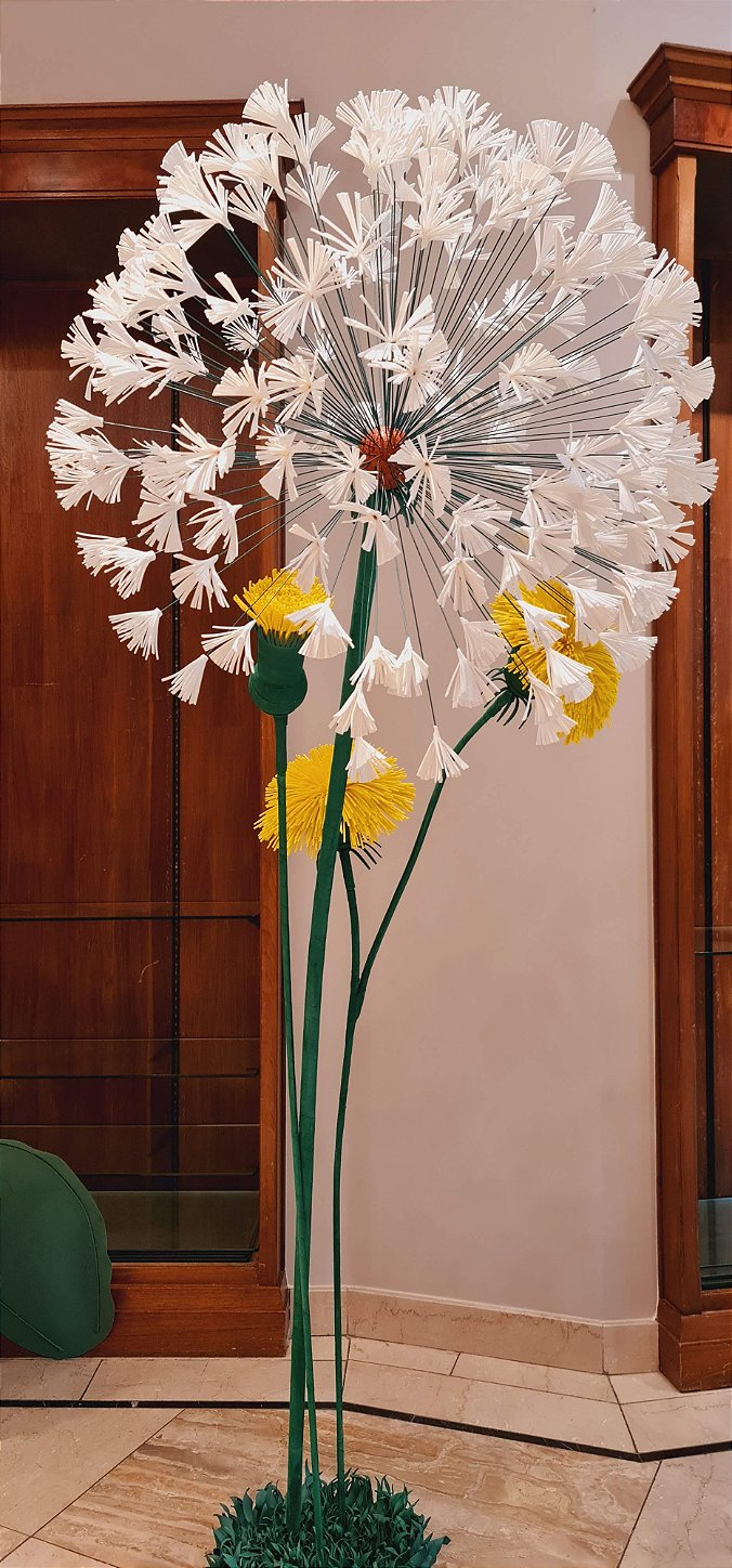 Color contrast between the giant flowers and the neon sign