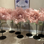 Row of large pink organza flowers on stands