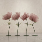 Row of stands with large pink organza flowers