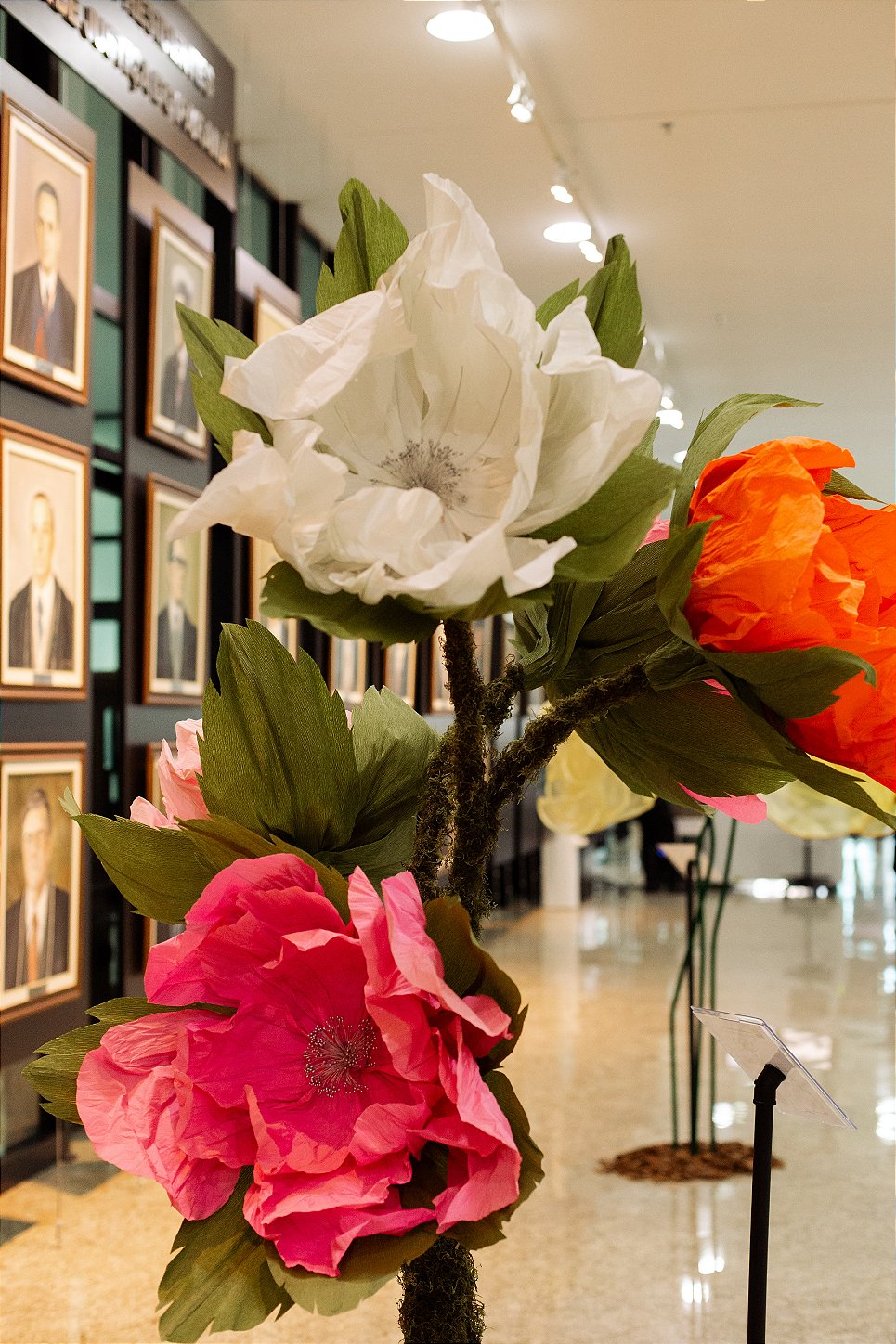 Giant organza butterflies suspended among the flowers - installation detail
