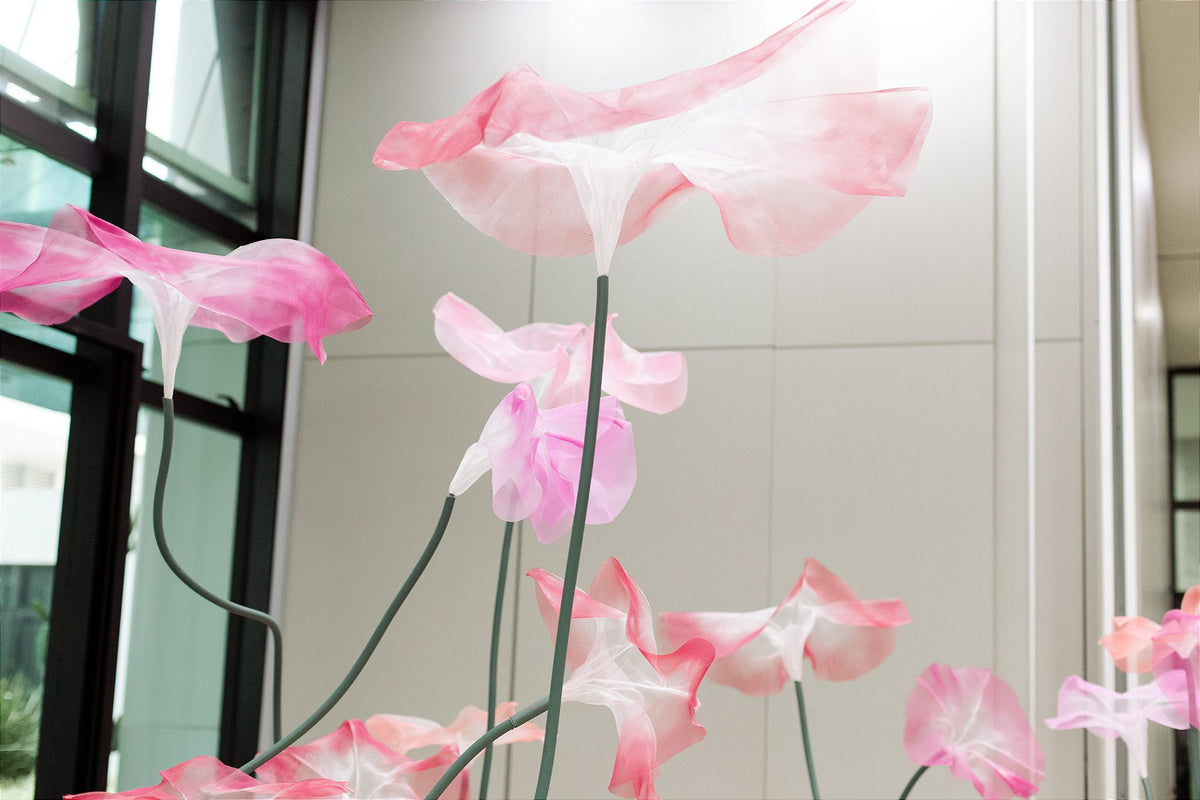 Close-up of the contrast between translucent organza and the glass architecture