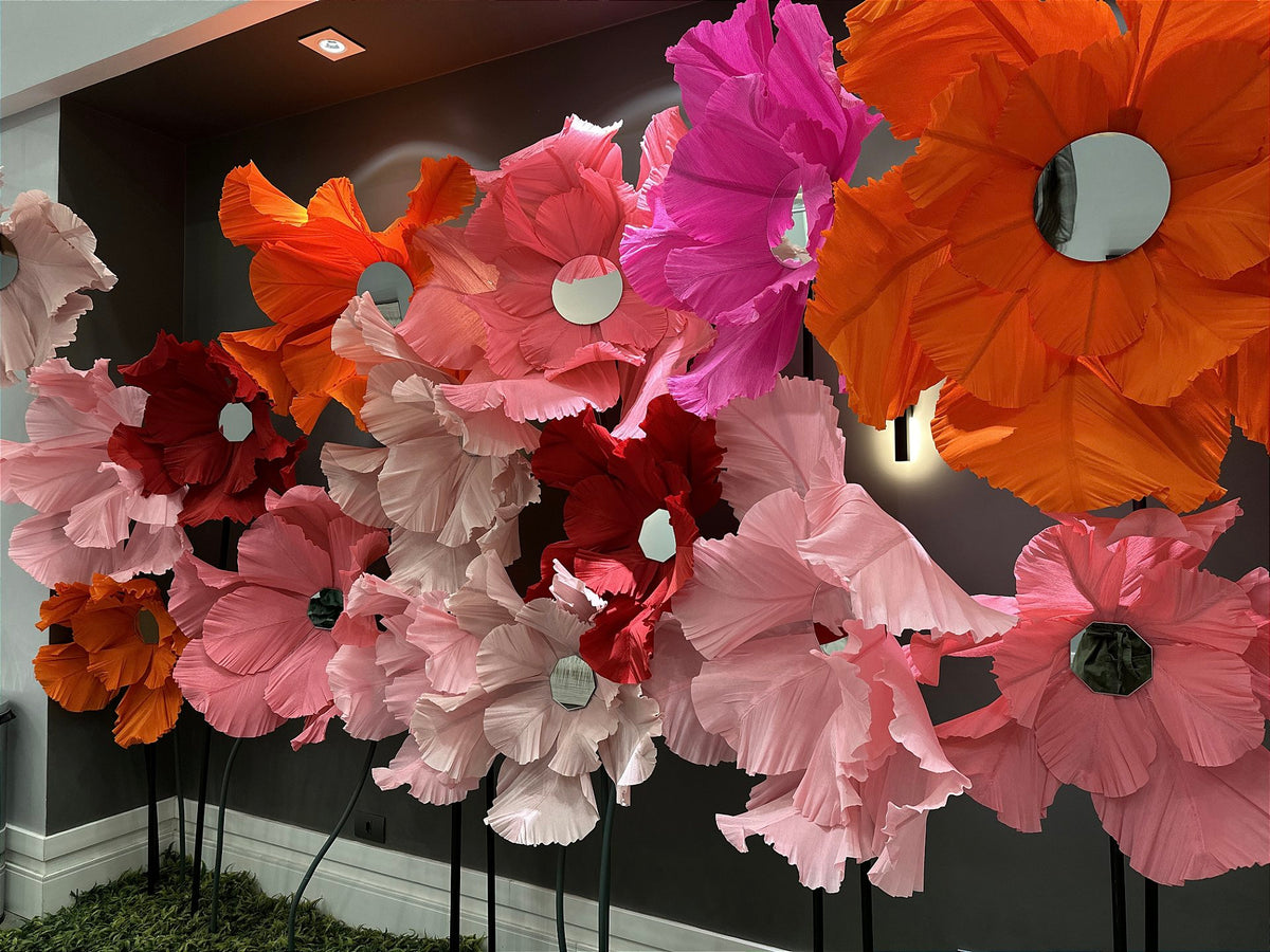 Scenic wall with giant Italian crepe paper flowers in vibrant tones