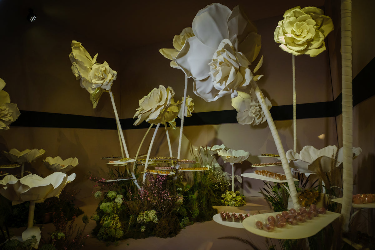 Dessert room with giant flowers doubling as trays for the fine sweets — full view