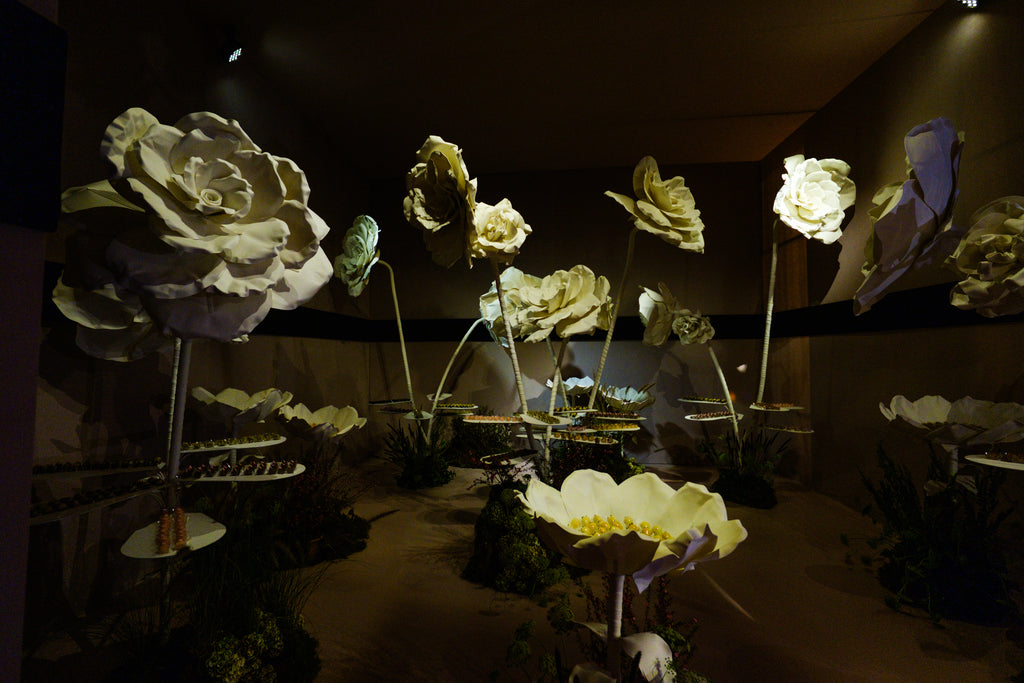 Giant flower arrangement in the dessert room with gold tones and suspended trays