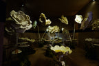 Giant flower arrangement in the dessert room with gold tones and suspended trays