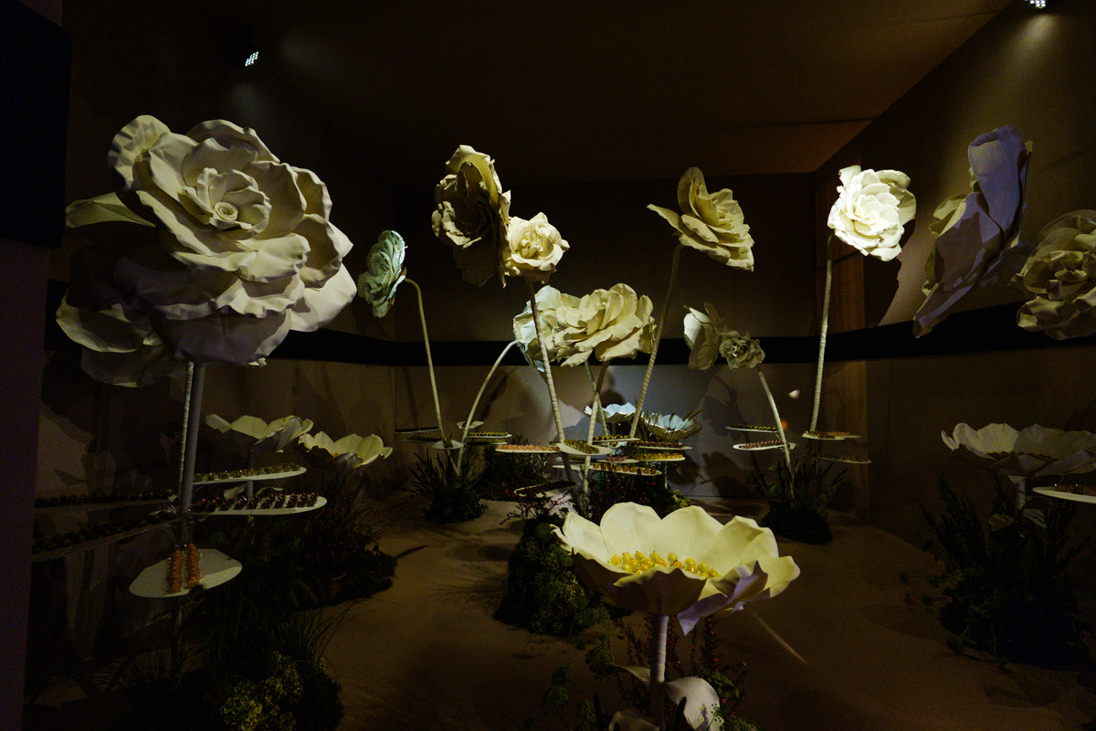 Giant flower arrangement in the dessert room with gold tones and suspended trays