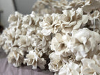 Macro detail of the EVA foam petal texture, giving the giant flowers a ceramic-like look