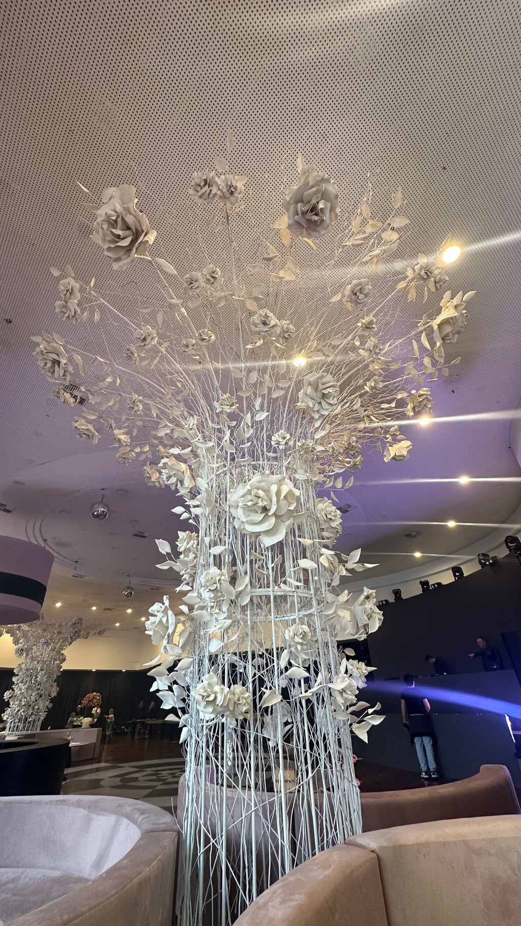 Tree of giant EVA foam flowers in the main hall, with the dance floor in the background