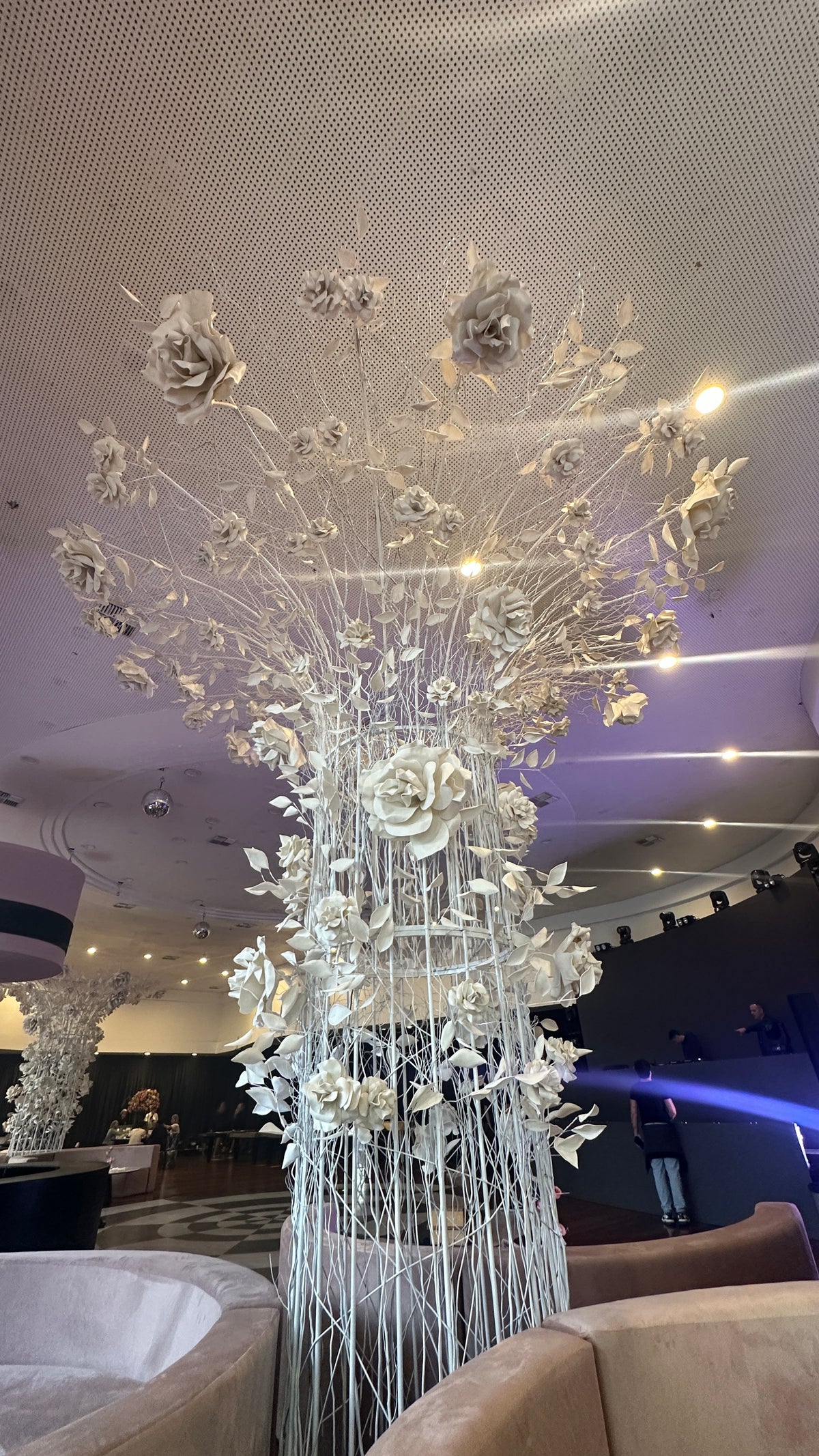 Tree of giant EVA foam flowers in the main hall, with the dance floor in the background