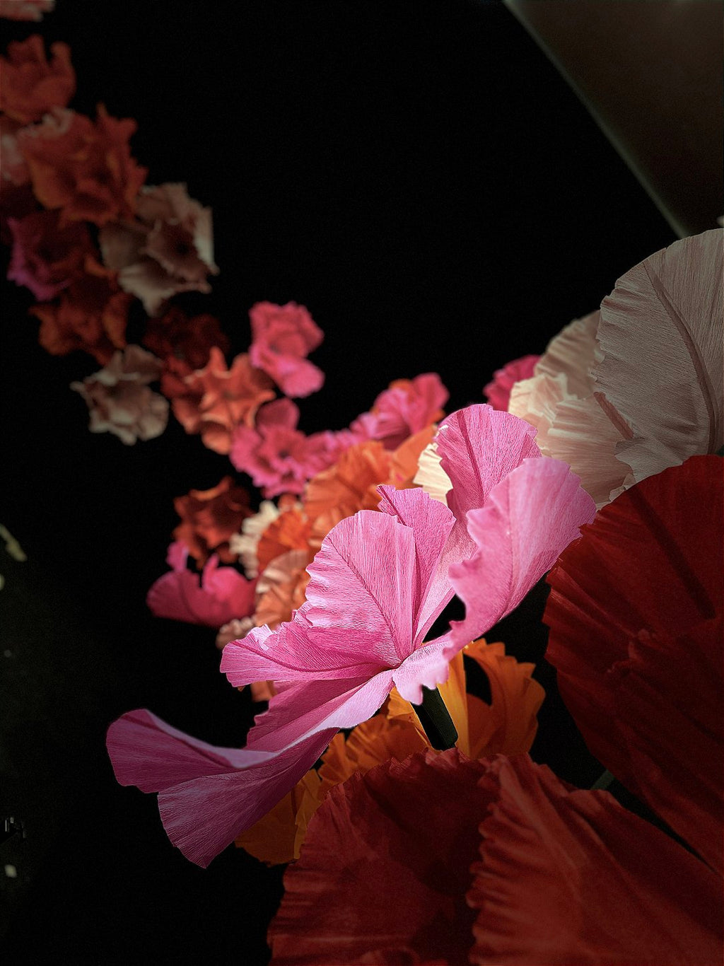 Long, sinuous stems with giant flowers growing up from the floor