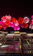 Guests interacting with the floral installation in warm tones