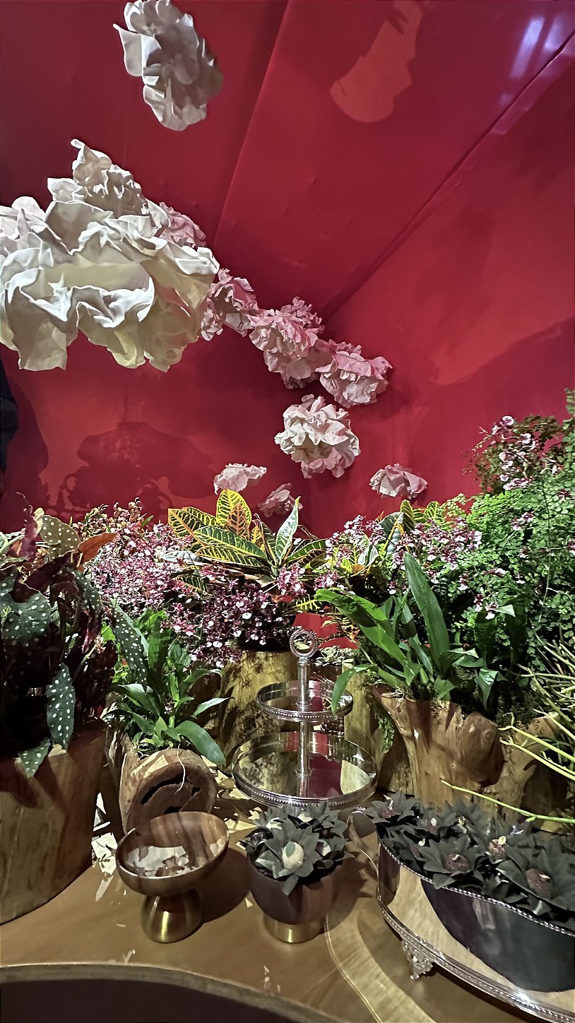 Overview of the hall decorated with giant EVA foam flowers and a terracotta wall