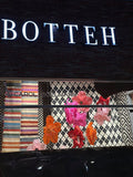Botteh Rugs storefront decorated with suspended giant flowers - overview
