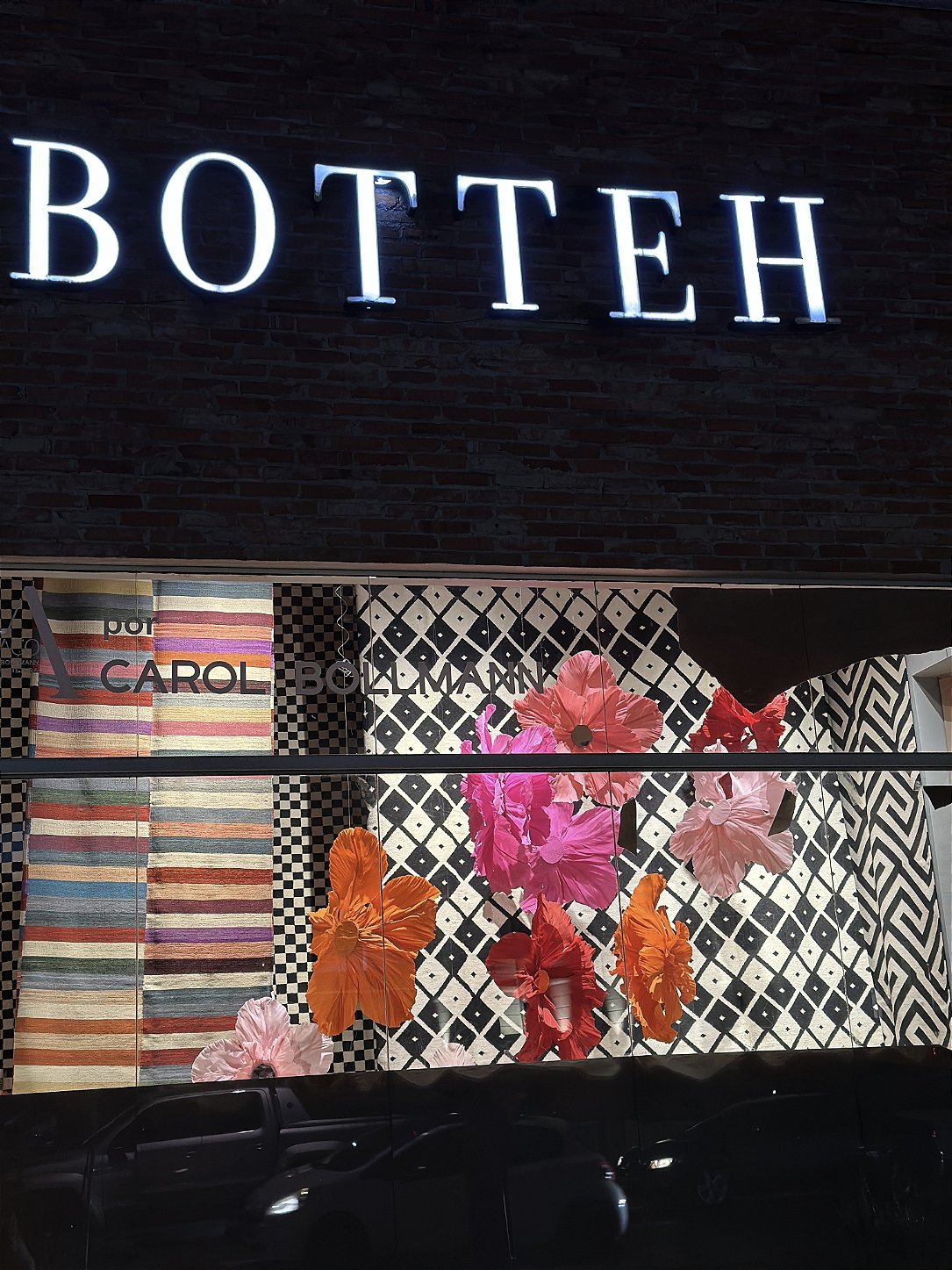 Botteh Rugs storefront decorated with suspended giant flowers - overview