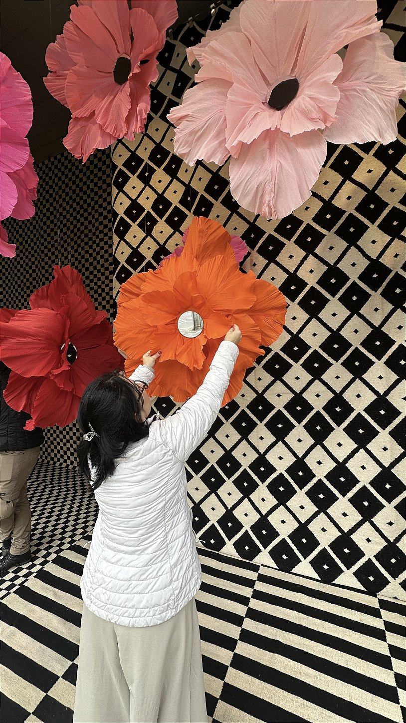 Final composition of the storefront with a suspended garden of giant flowers