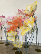 Giant organza flowers in yellow and orange tones - immersive installation at Chefs' Night