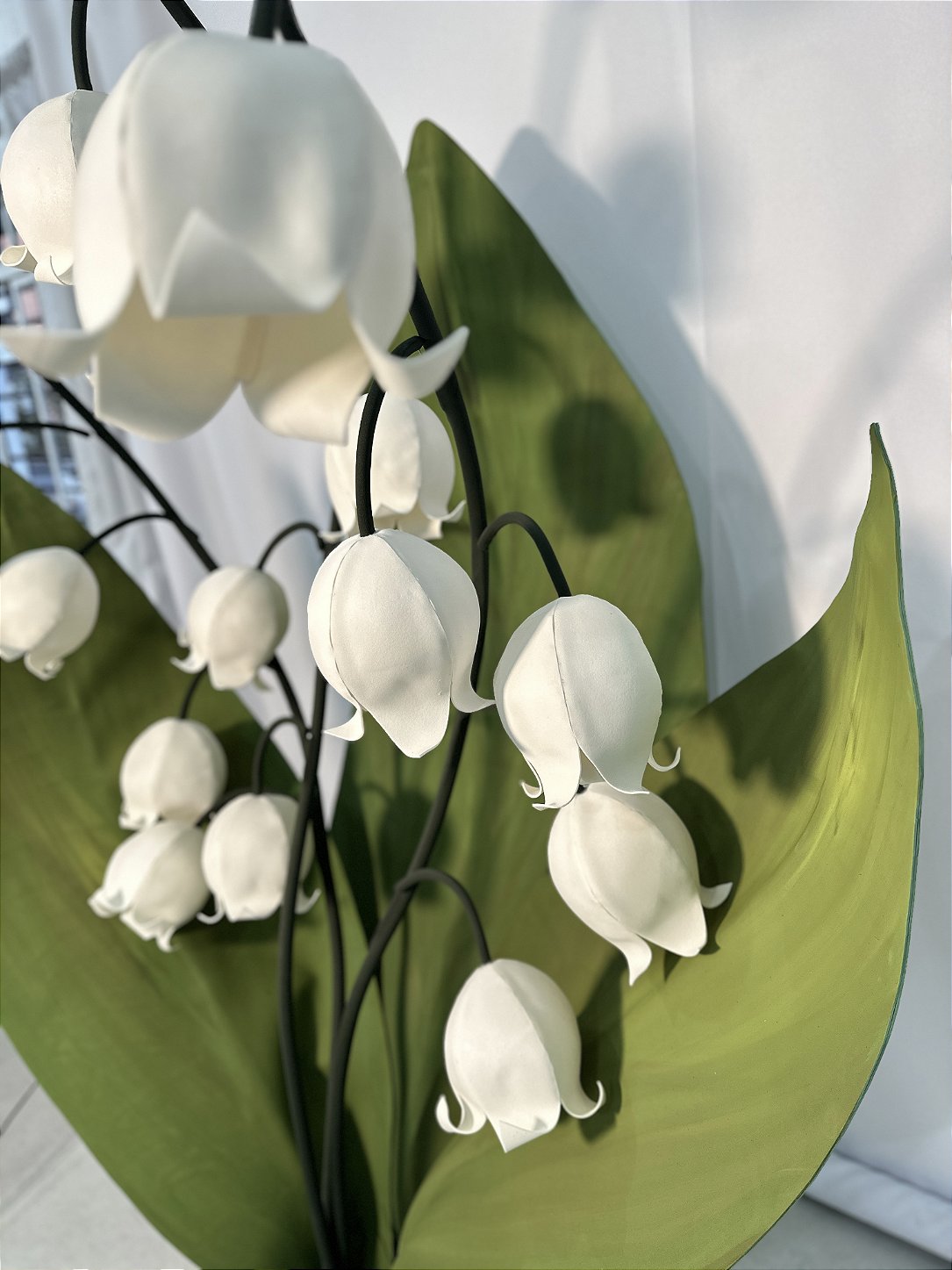 Outdoor wedding installation with giant EVA foam flowers