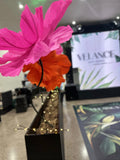 Giant off-white EVA foam rose applied to a stone wall - Velance Hair & Beauty lounge