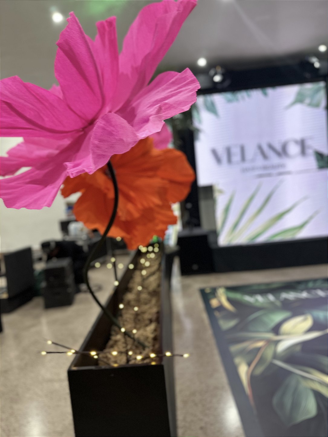 Giant off-white EVA foam rose applied to a stone wall - Velance Hair & Beauty lounge