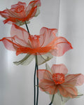Trio of handcrafted organza daffodils on a decorative table