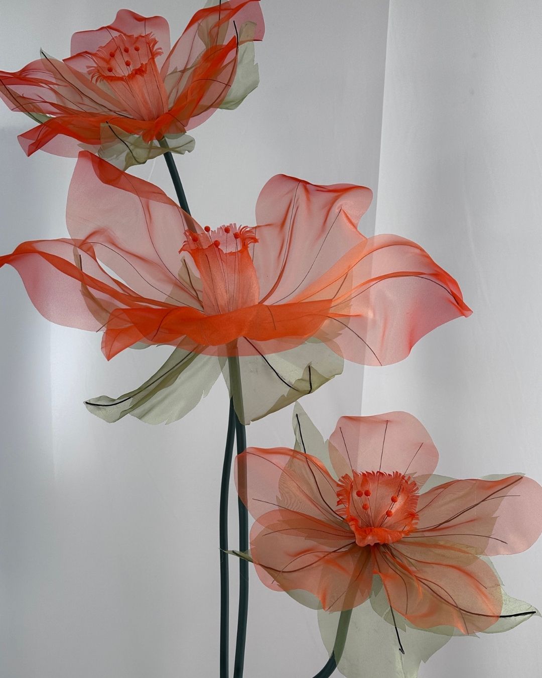 Trio of handcrafted organza daffodils on a decorative table